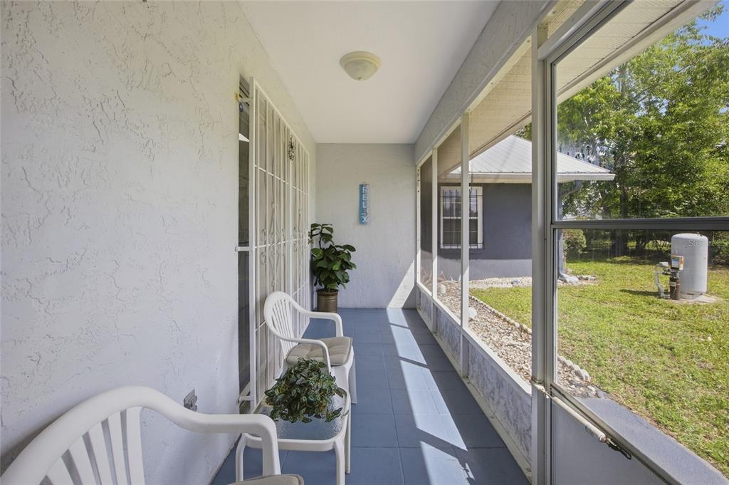 549 Silver Course Run Ocala, FL 34472 - Photo 34 of 48 a porch with a table and chairs