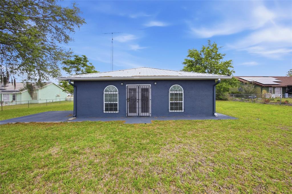 549 Silver Course Run Ocala, FL 34472 - Photo 37 of 48 a view of a house with backyard porch and garden