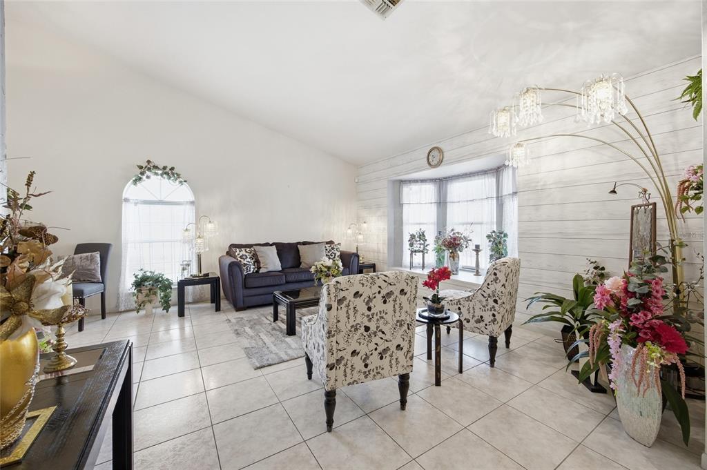 549 Silver Course Run Ocala, FL 34472 - Photo 7 of 48 a living room with furniture and a chandelier