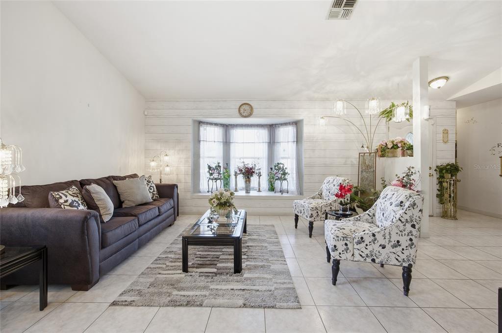 549 Silver Course Run Ocala, FL 34472 - Photo 8 of 48 a living room with furniture and a large window