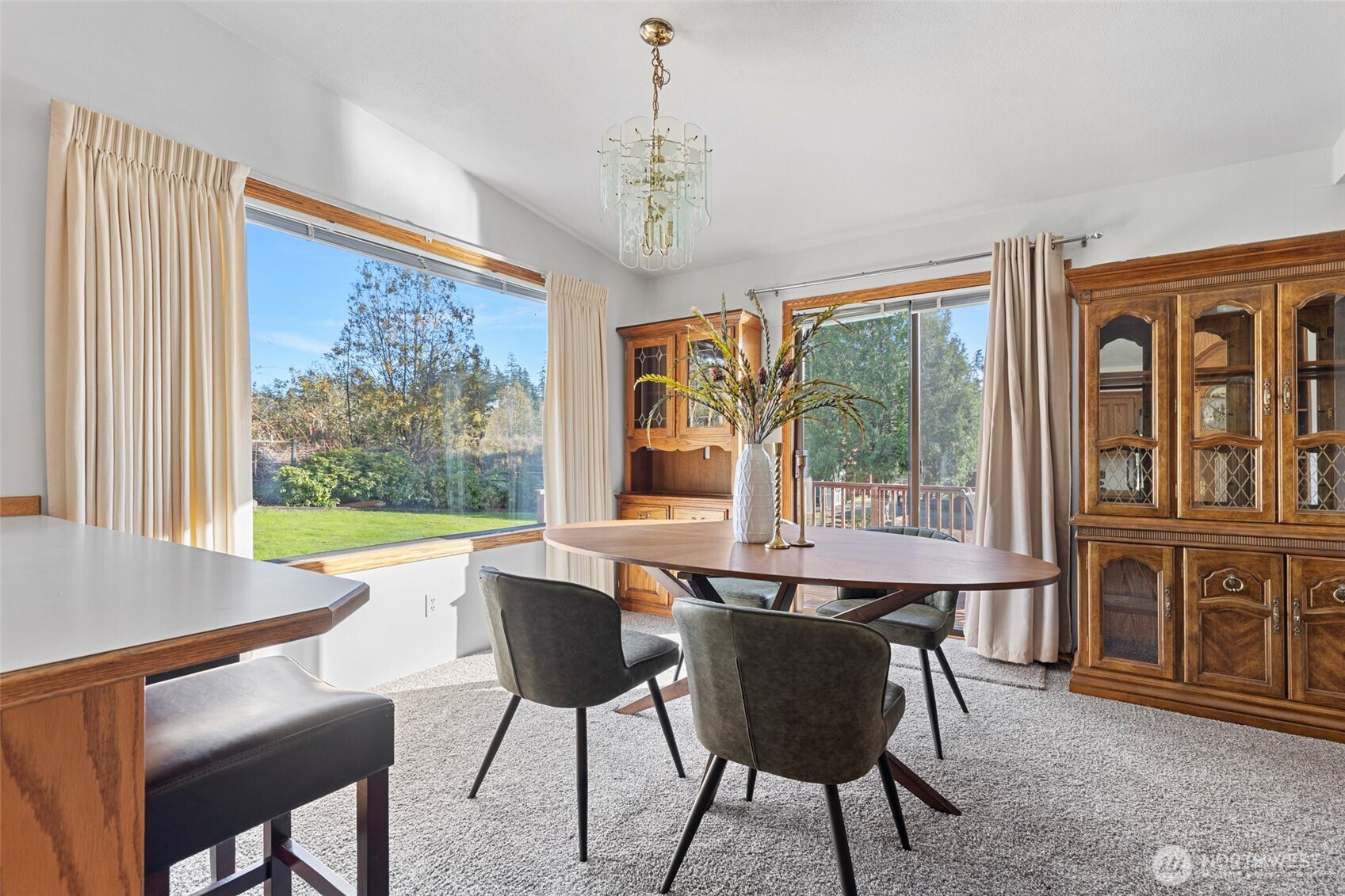 288 Torrence Lane Oak Harbor, WA 98277 - Photo 12 of 39 a dining room with furniture large windows and a chandelier