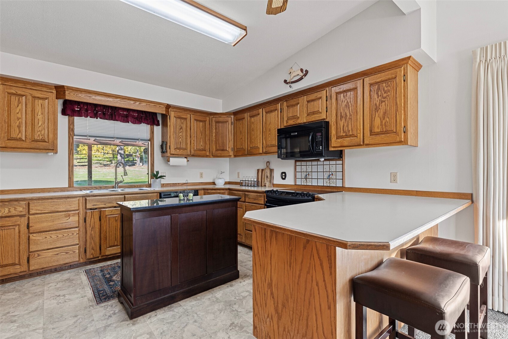 288 Torrence Lane Oak Harbor, WA 98277 - Photo 13 of 39 a kitchen with a stove a sink a microwave and a refrigerator