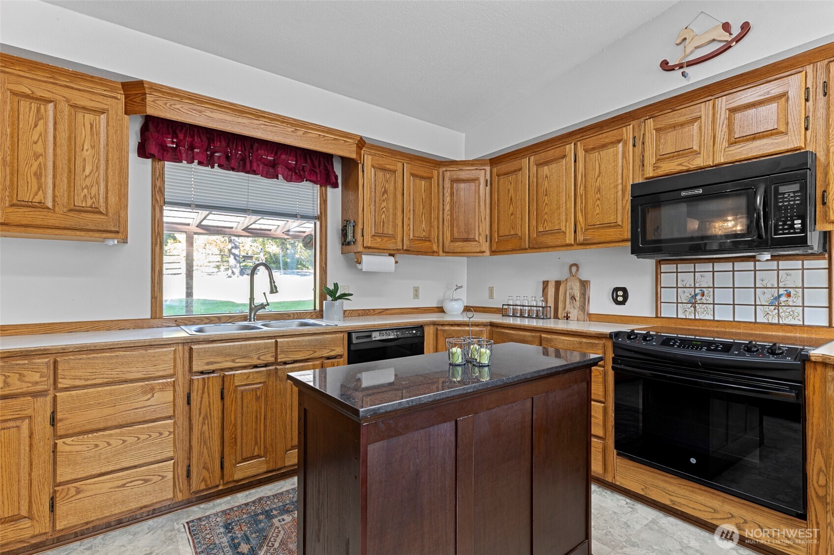 288 Torrence Lane Oak Harbor, WA 98277 - Photo 14 of 39 a kitchen with stainless steel appliances a stove sink microwave and cabinets
