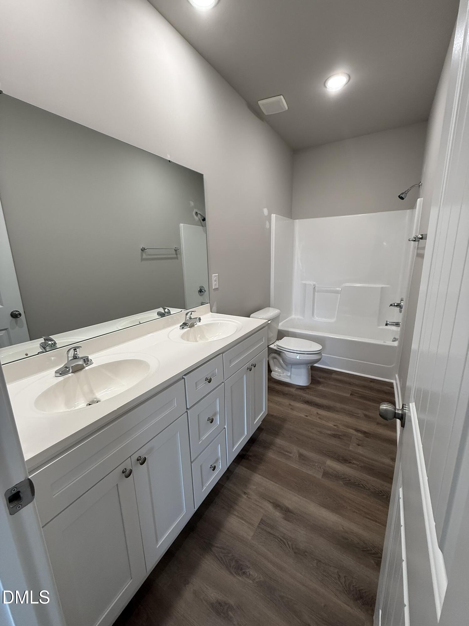 180 Jacobs Ridge Drive Four Oaks, NC 27524 - Photo 14 of 20 a bathroom with a double vanity sink and mirror