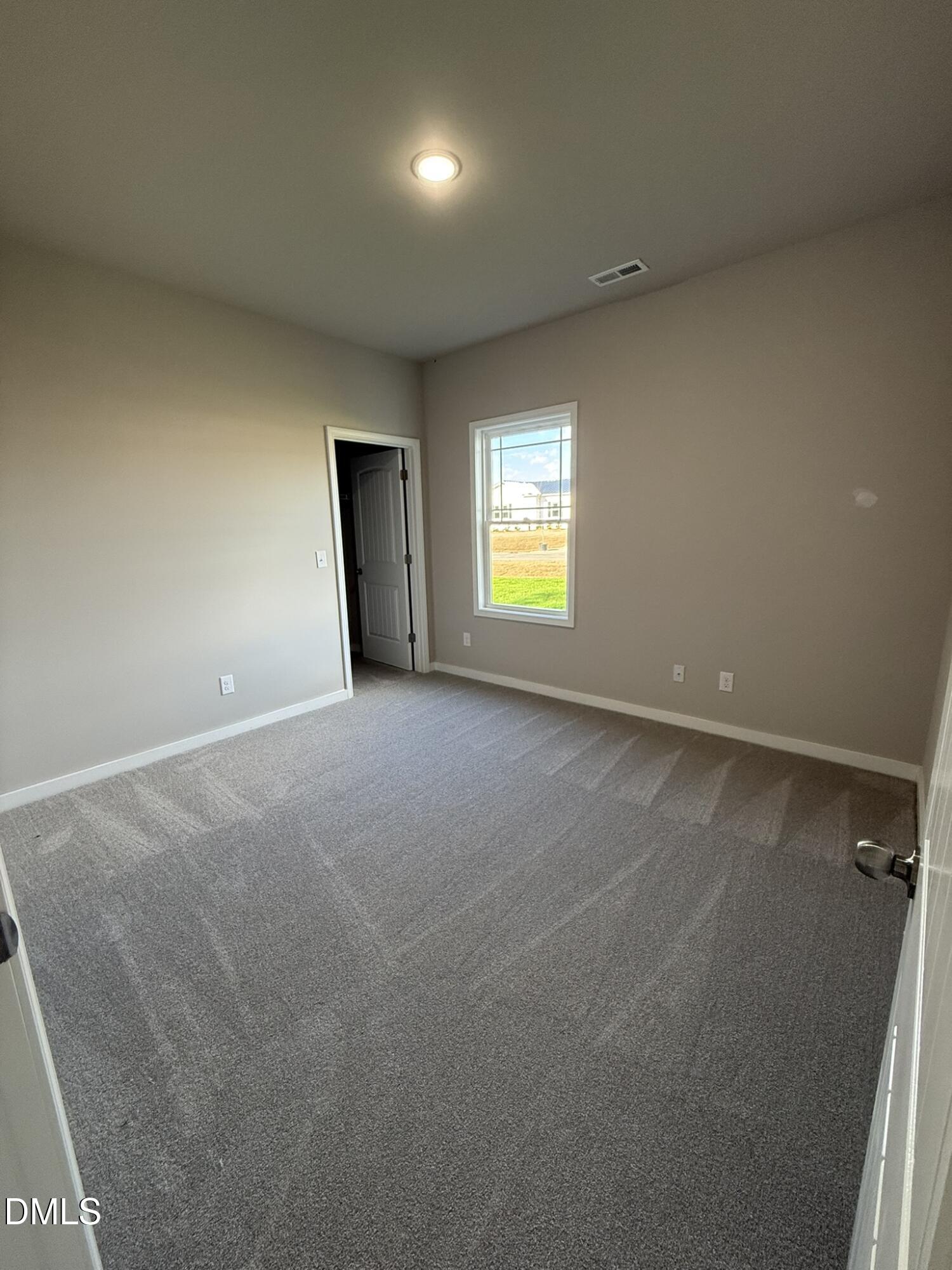180 Jacobs Ridge Drive Four Oaks, NC 27524 - Photo 15 of 20 an empty room with a window and a fireplace