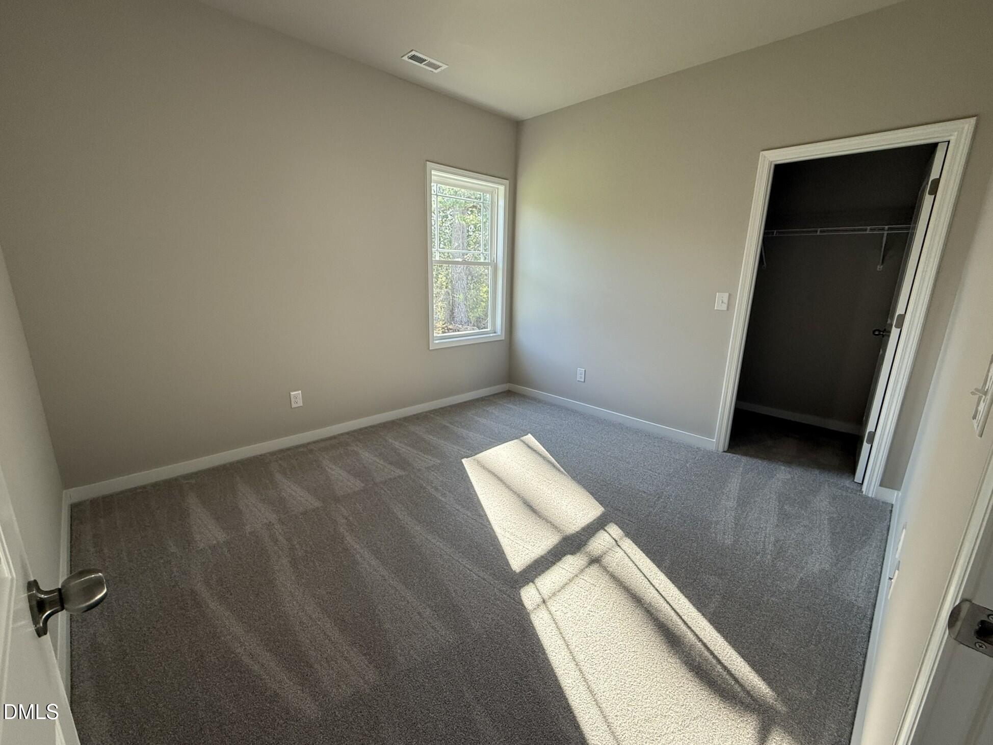 180 Jacobs Ridge Drive Four Oaks, NC 27524 - Photo 16 of 20 an empty room with windows