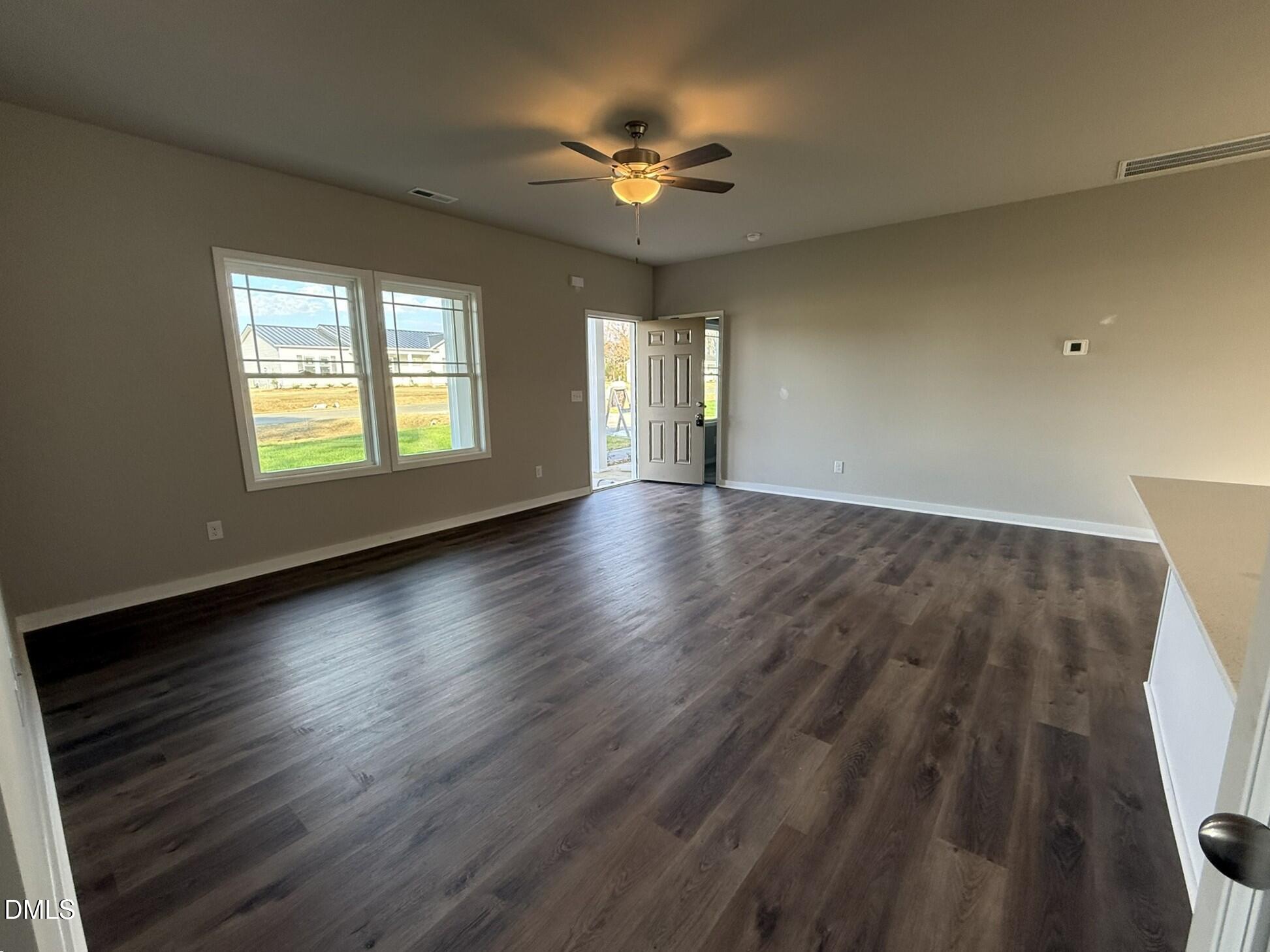 180 Jacobs Ridge Drive Four Oaks, NC 27524 - Photo 4 of 20 an empty room with wooden floor and windows