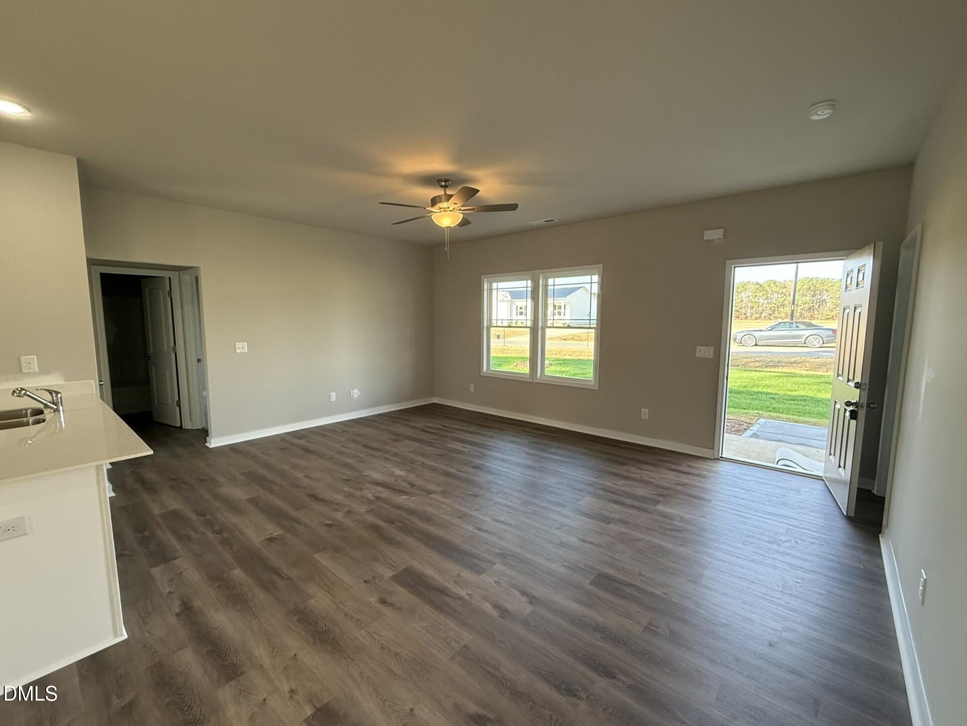 180 Jacobs Ridge Drive Four Oaks, NC 27524 - Photo 5 of 20 a view of an empty room with window and wooden floor