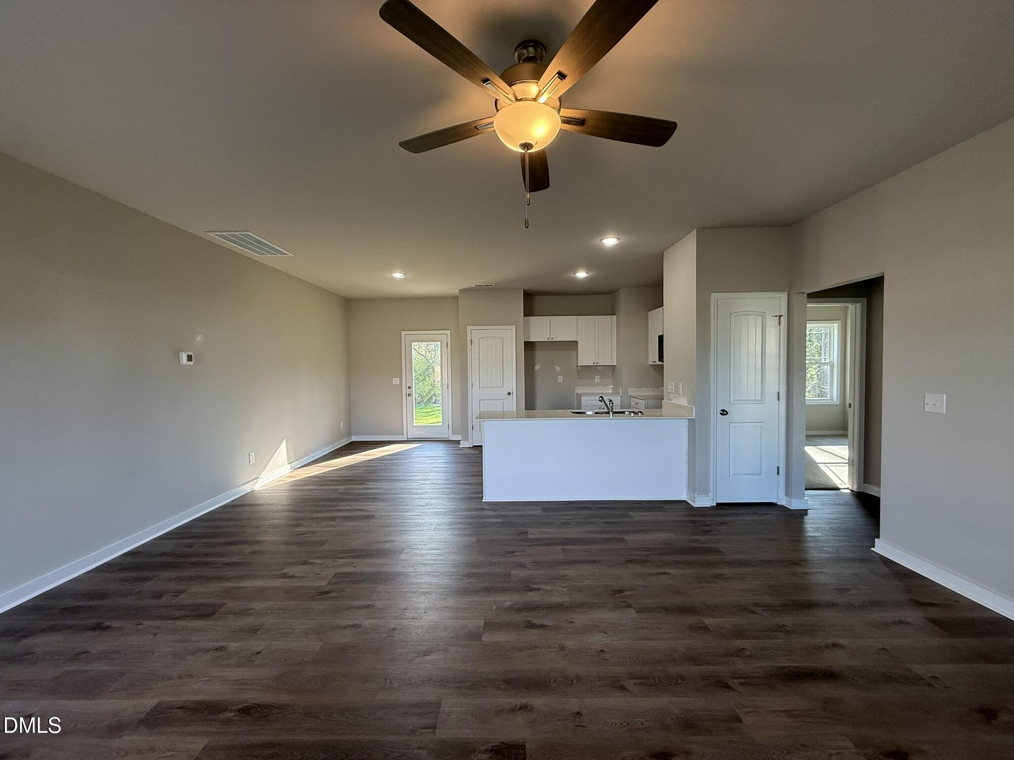 180 Jacobs Ridge Drive Four Oaks, NC 27524 - Photo 7 of 20 a view of empty room with wooden floor and ceiling fan