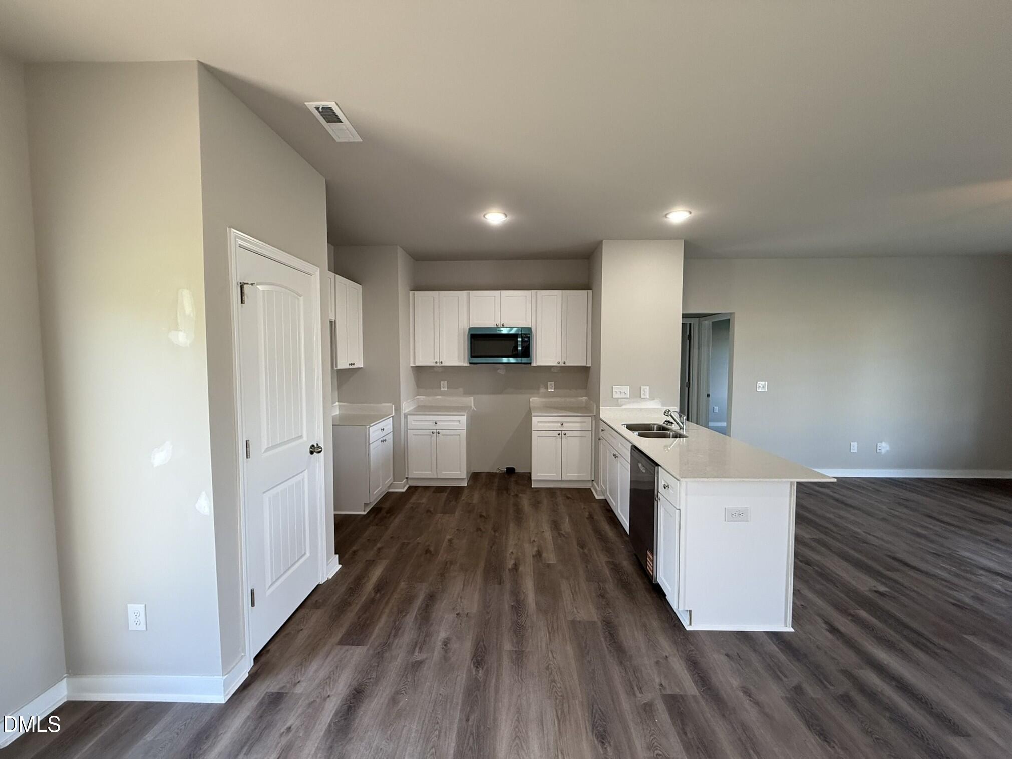 180 Jacobs Ridge Drive Four Oaks, NC 27524 - Photo 9 of 20 a large kitchen with a wooden floor and stainless steel appliances