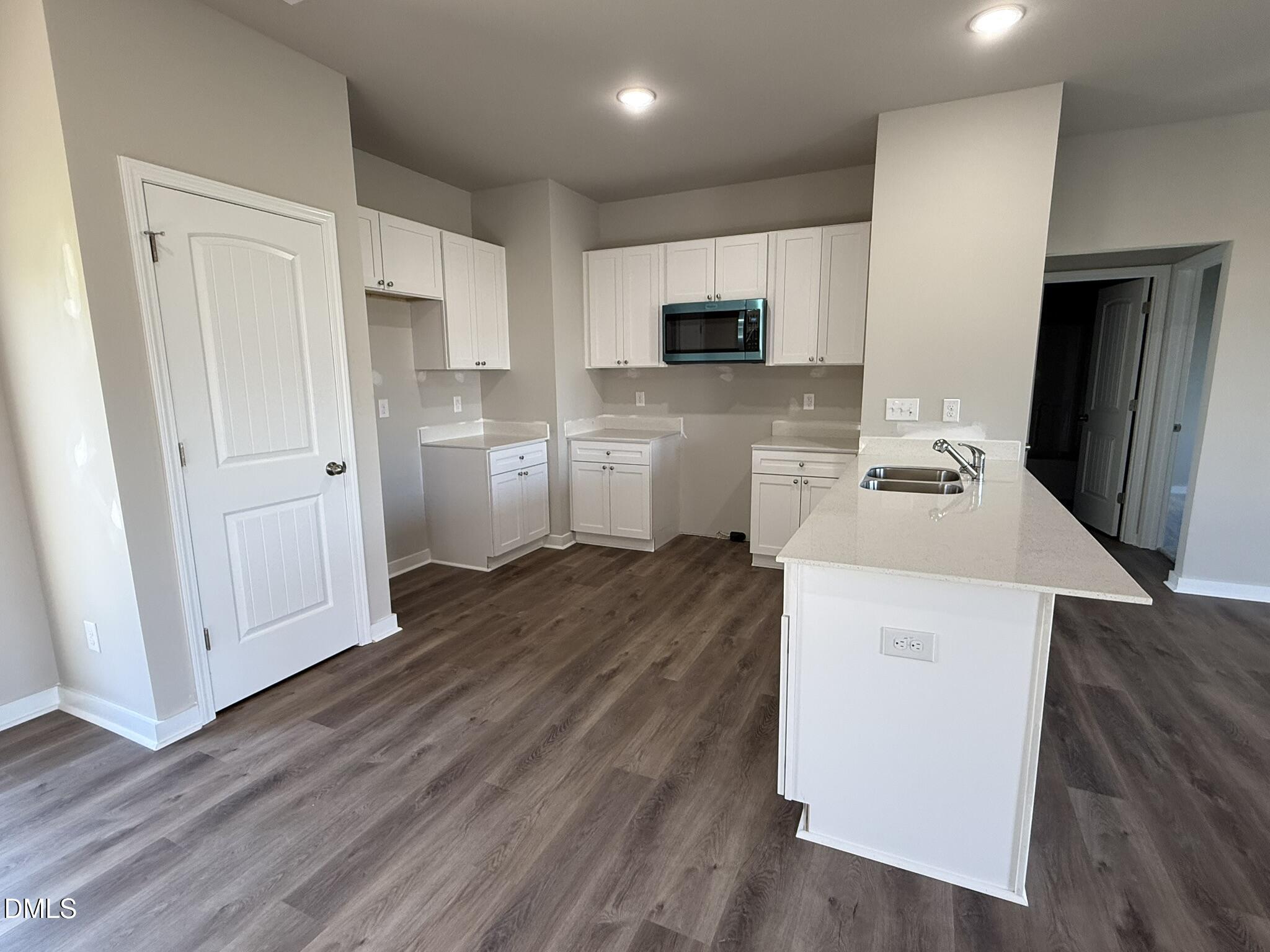 180 Jacobs Ridge Drive Four Oaks, NC 27524 - Photo 10 of 20 a kitchen with cabinets and wooden floor