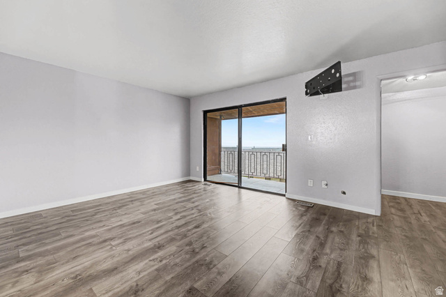 34 Benchmark Village Tooele, UT 84074 - Photo 13 of 35 Unfurnished room with wood finished floors and baseboards