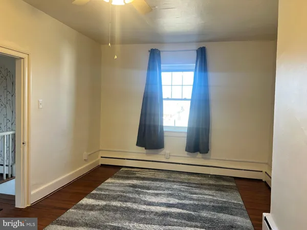 wooden floor in an empty room with a fireplace