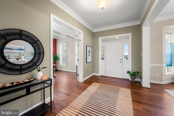 a living room with furniture a large window and a flat screen tv