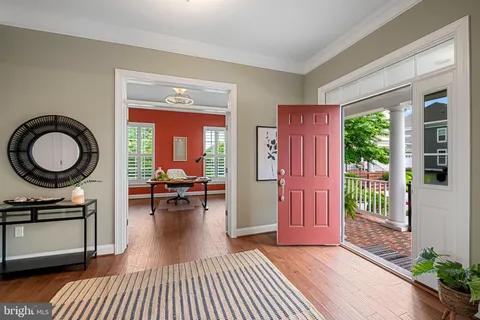 a living room with furniture and a dining table with kitchen view