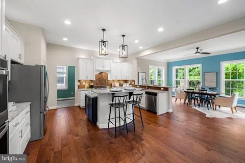 a dining room with furniture window and wooden floor