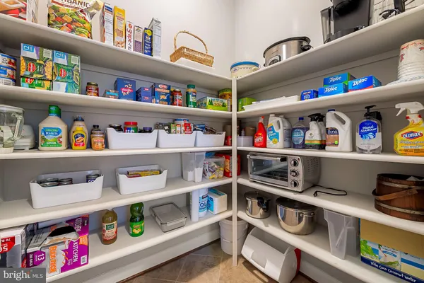 a dining room with stainless steel appliances kitchen island granite countertop a table chairs and a refrigerator