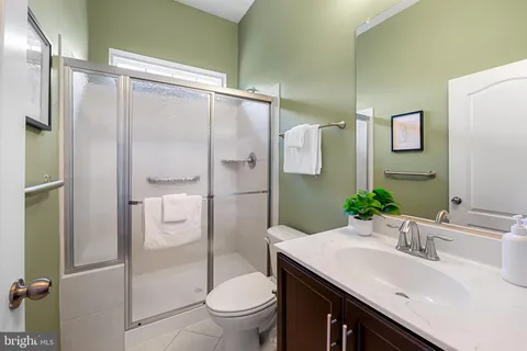 a bedroom with furniture and a large window