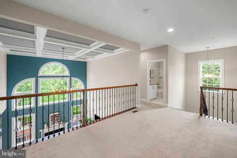 a spacious bedroom with a bed and a chandelier