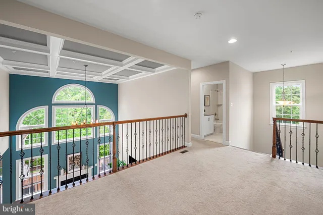 a spacious bedroom with a bed and a chandelier