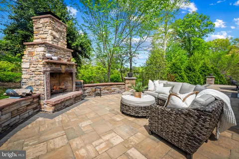 a dining room with furniture a chandelier and wooden floor
