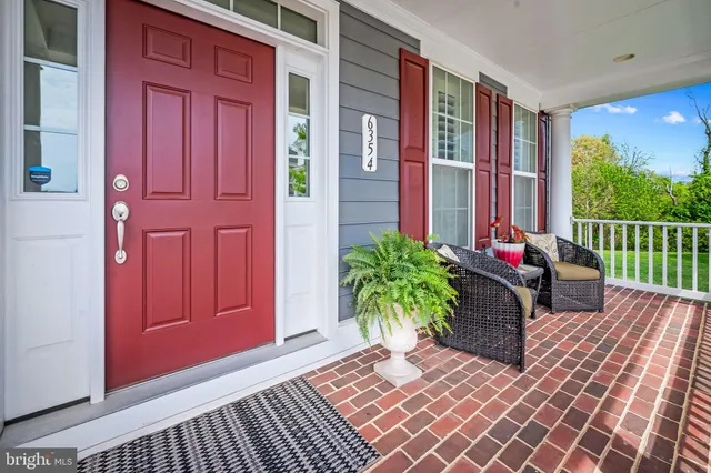 a dining room with furniture a rug and a chandelier