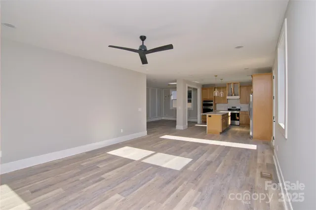 a view of a kitchen with wooden floor and a kitchen