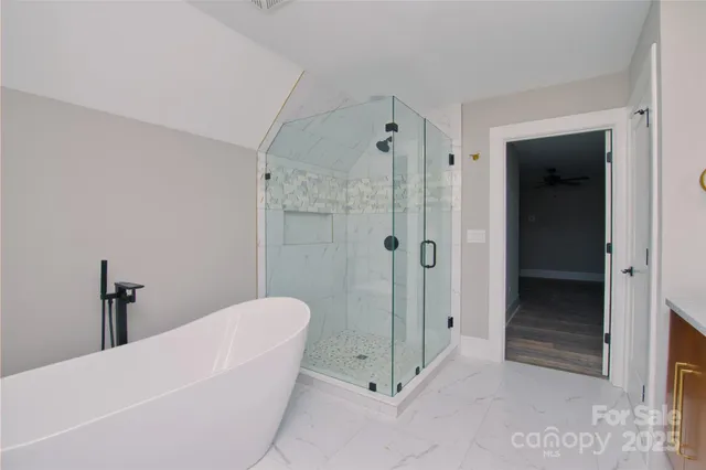 a bathroom with a tub and shower