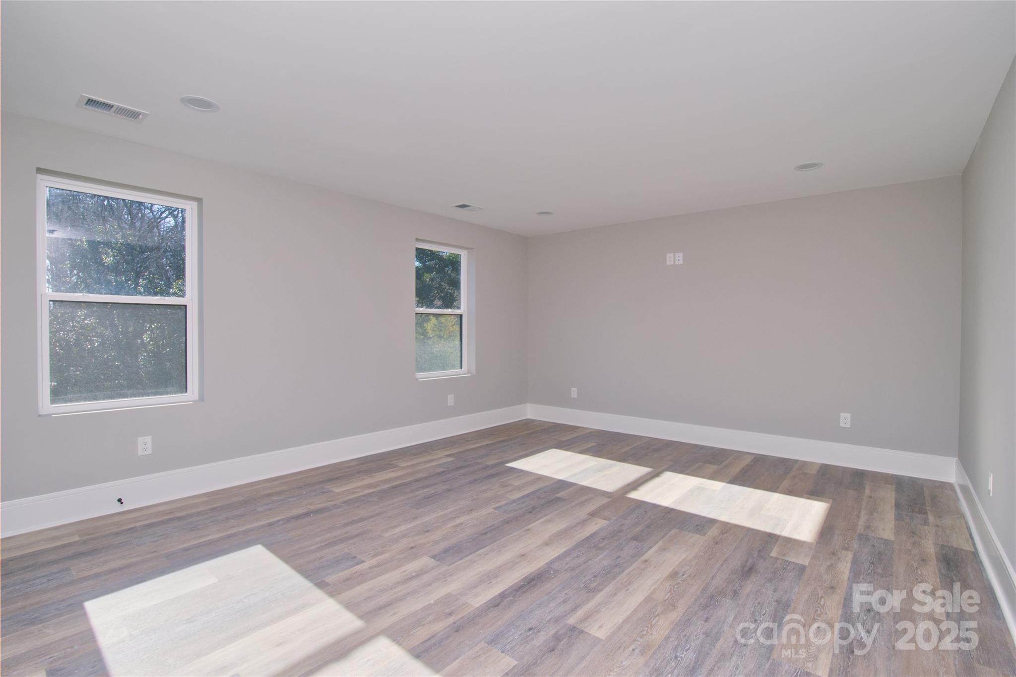 3905 Plainview Road Charlotte, NC 28208 - Photo 32 of 45 a view of an empty room with wooden floor and a window