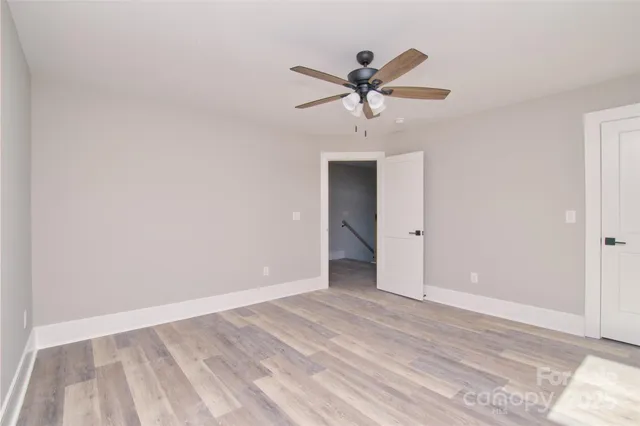 a view of a room with a sink and wooden floor