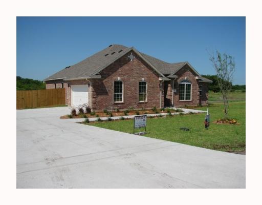 a view of a house with a yard and table under an umbrella