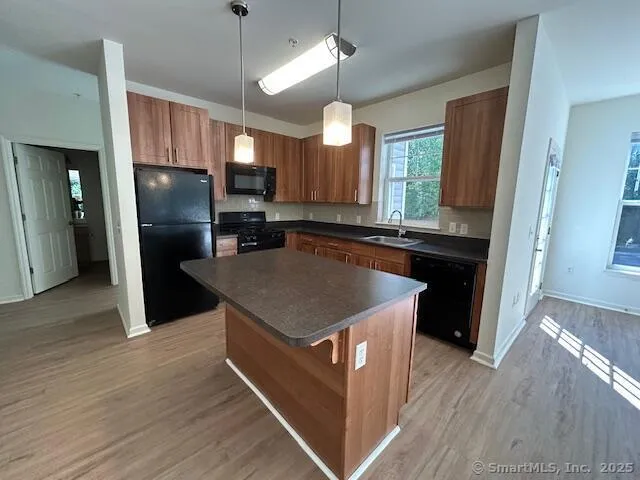 a kitchen with stainless steel appliances granite countertop a refrigerator a sink and a stove