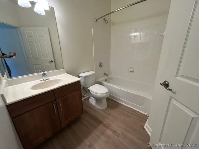 a bathroom with a sink a toilet a shower and a mirror