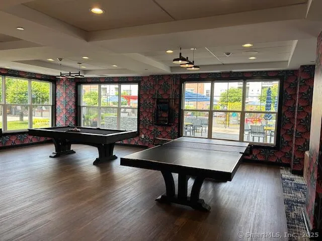 a living room with pool table furniture and a large window