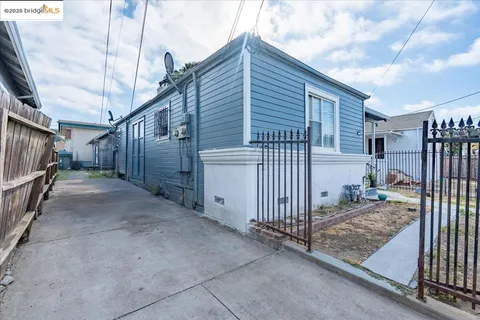 a view of a house with wooden fence