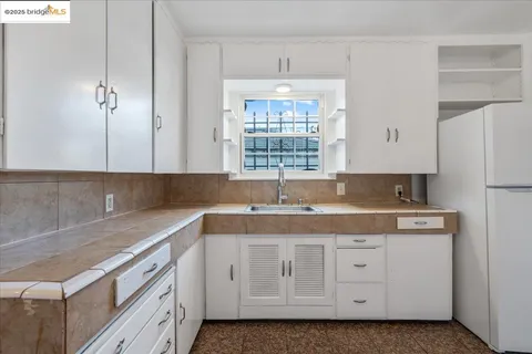 a kitchen with cabinets appliances a sink and a window
