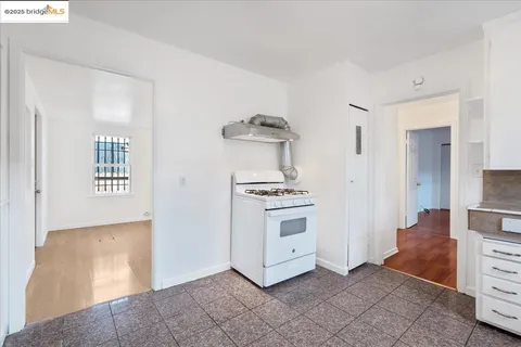 a kitchen with stainless steel appliances white cabinets and a refrigerator