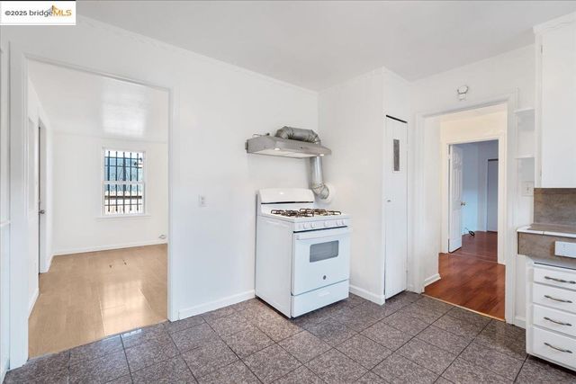 a kitchen with stainless steel appliances white cabinets and a refrigerator