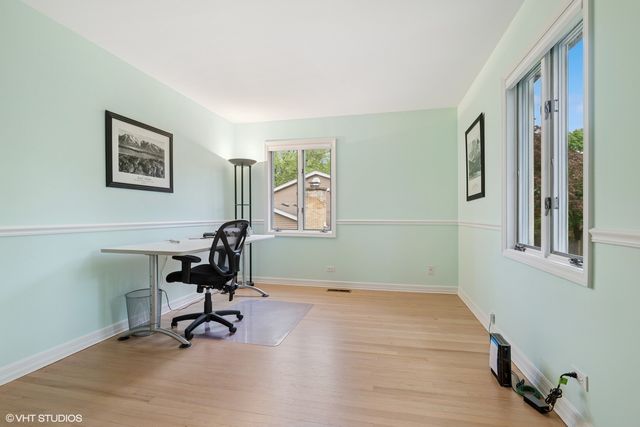 a view of a workspace with furniture and a window