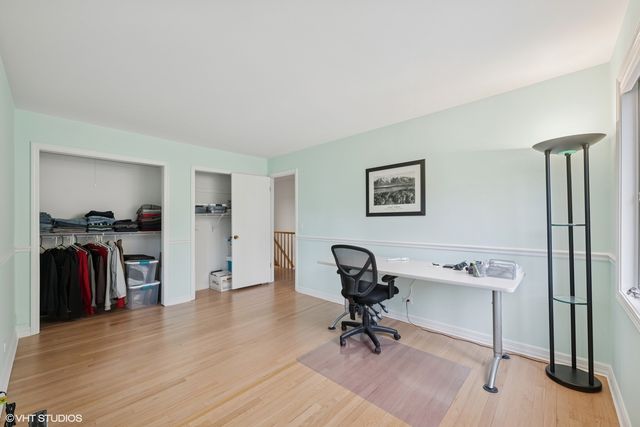 a view of a workspace with furniture and a window