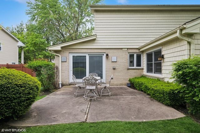 a view of a patio with table and chairs and potted plants