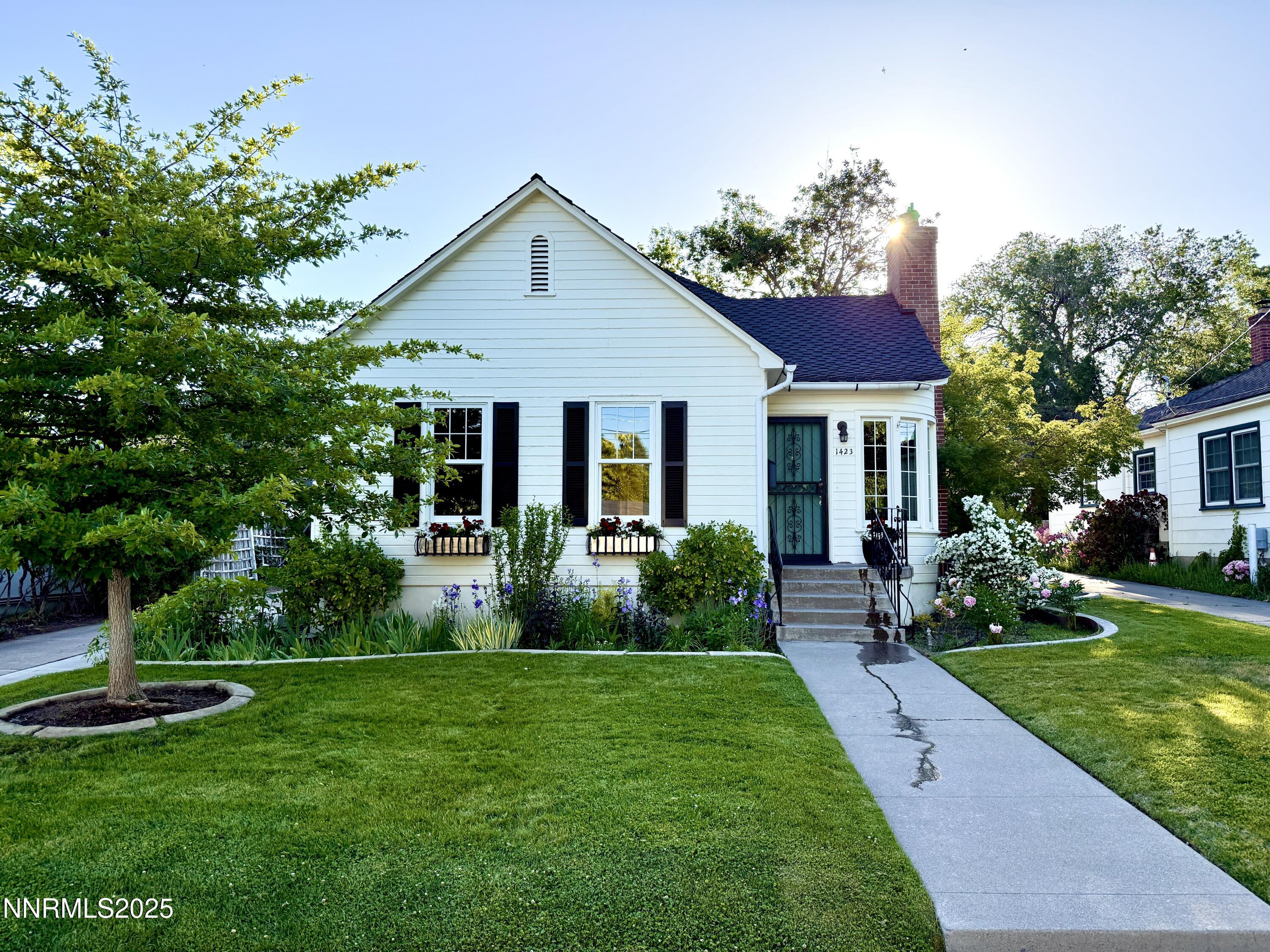 1423 Gordon Avenue Reno, NV 89509 - Photo 1 of 28 a front view of a house with a yard and green space