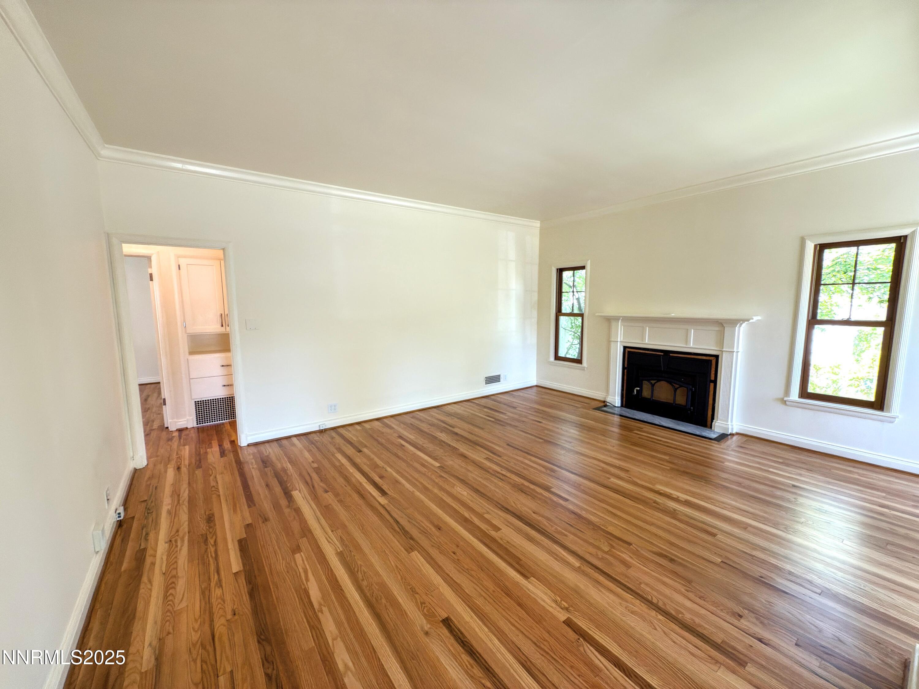 1423 Gordon Avenue Reno, NV 89509 - Photo 11 of 28 a view of empty room with wooden floor and fireplace