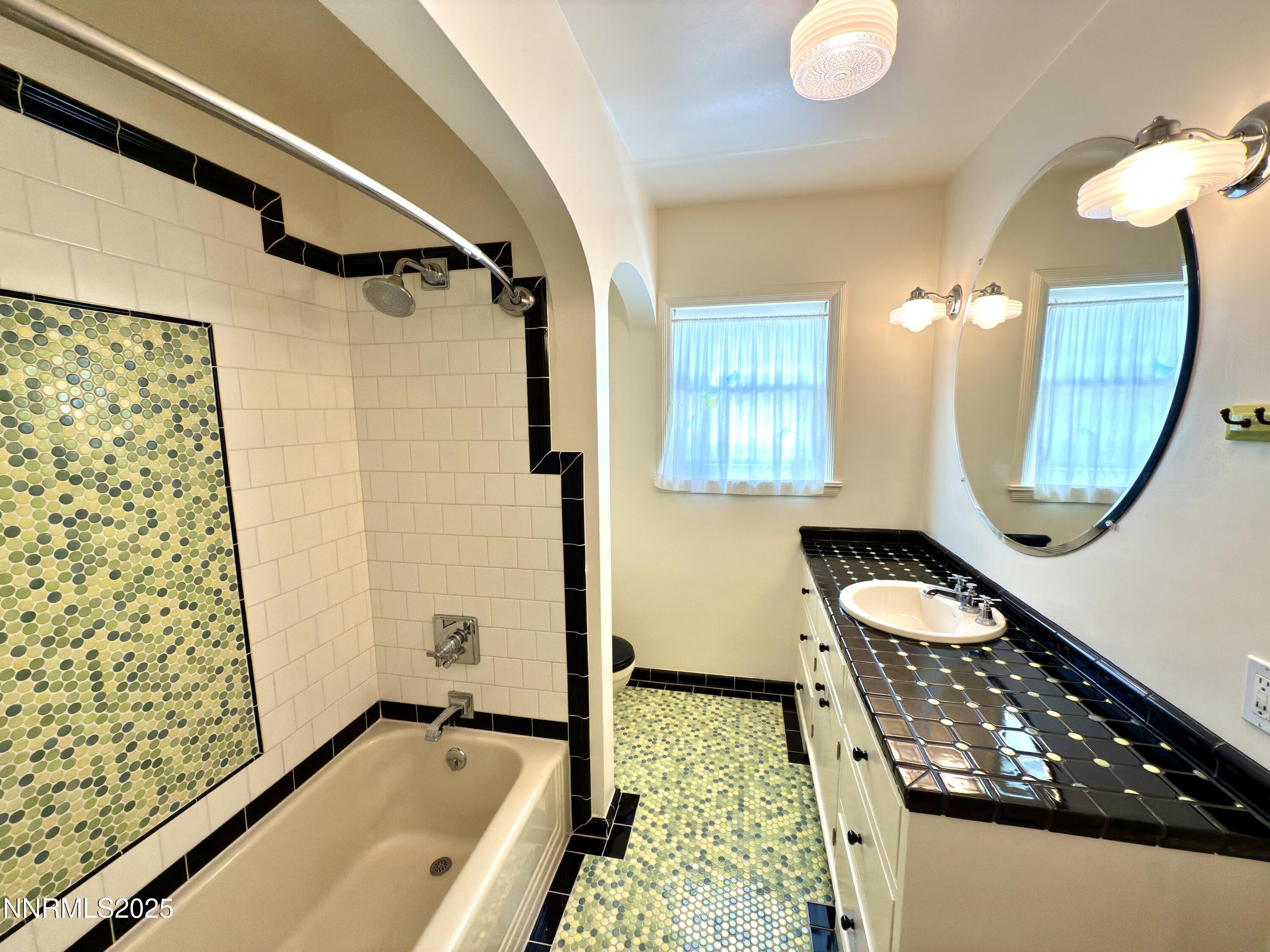 1423 Gordon Avenue Reno, NV 89509 - Photo 15 of 28 a bathroom with a tub sink and mirror