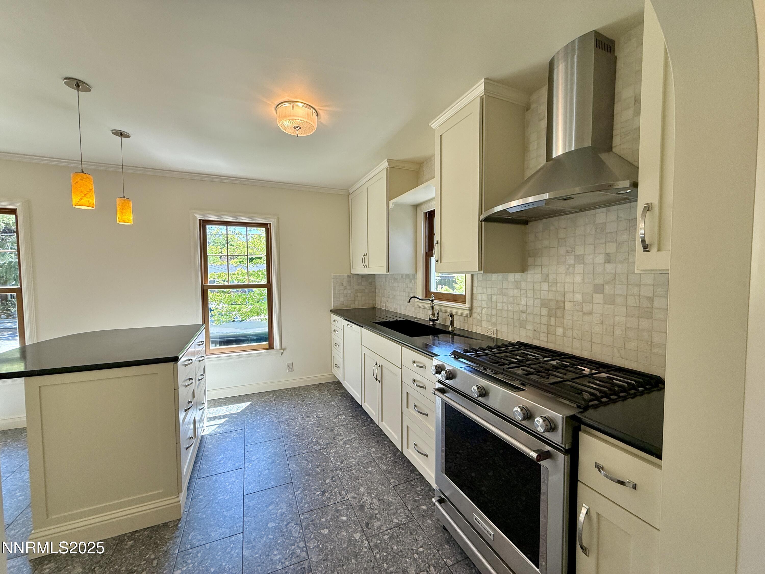 1423 Gordon Avenue Reno, NV 89509 - Photo 4 of 28 a kitchen with stainless steel appliances granite countertop a stove a sink and a refrigerator