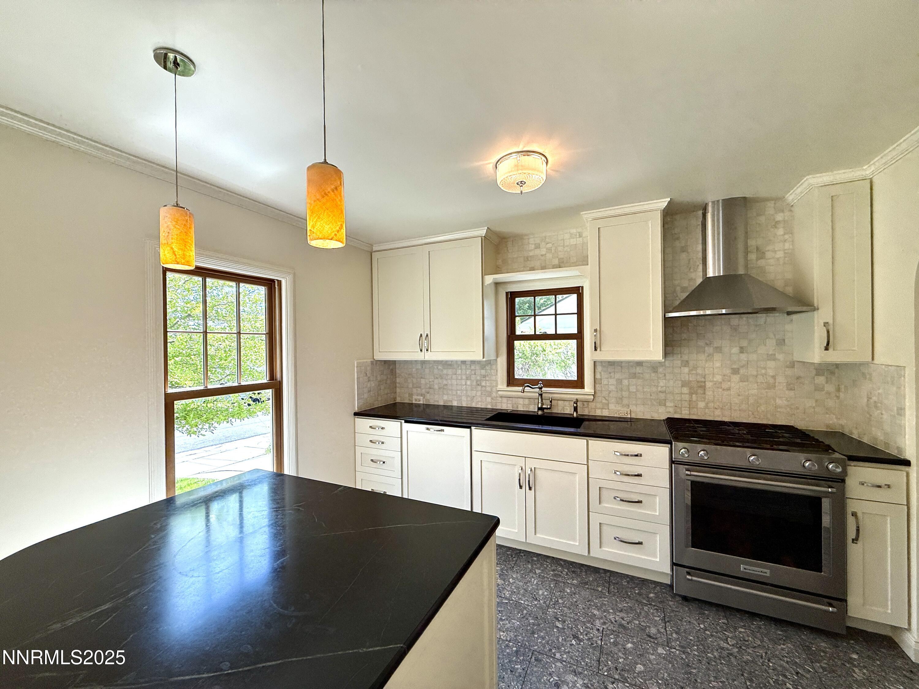 1423 Gordon Avenue Reno, NV 89509 - Photo 5 of 28 a kitchen with stainless steel appliances granite countertop a stove a sink and a wooden floors