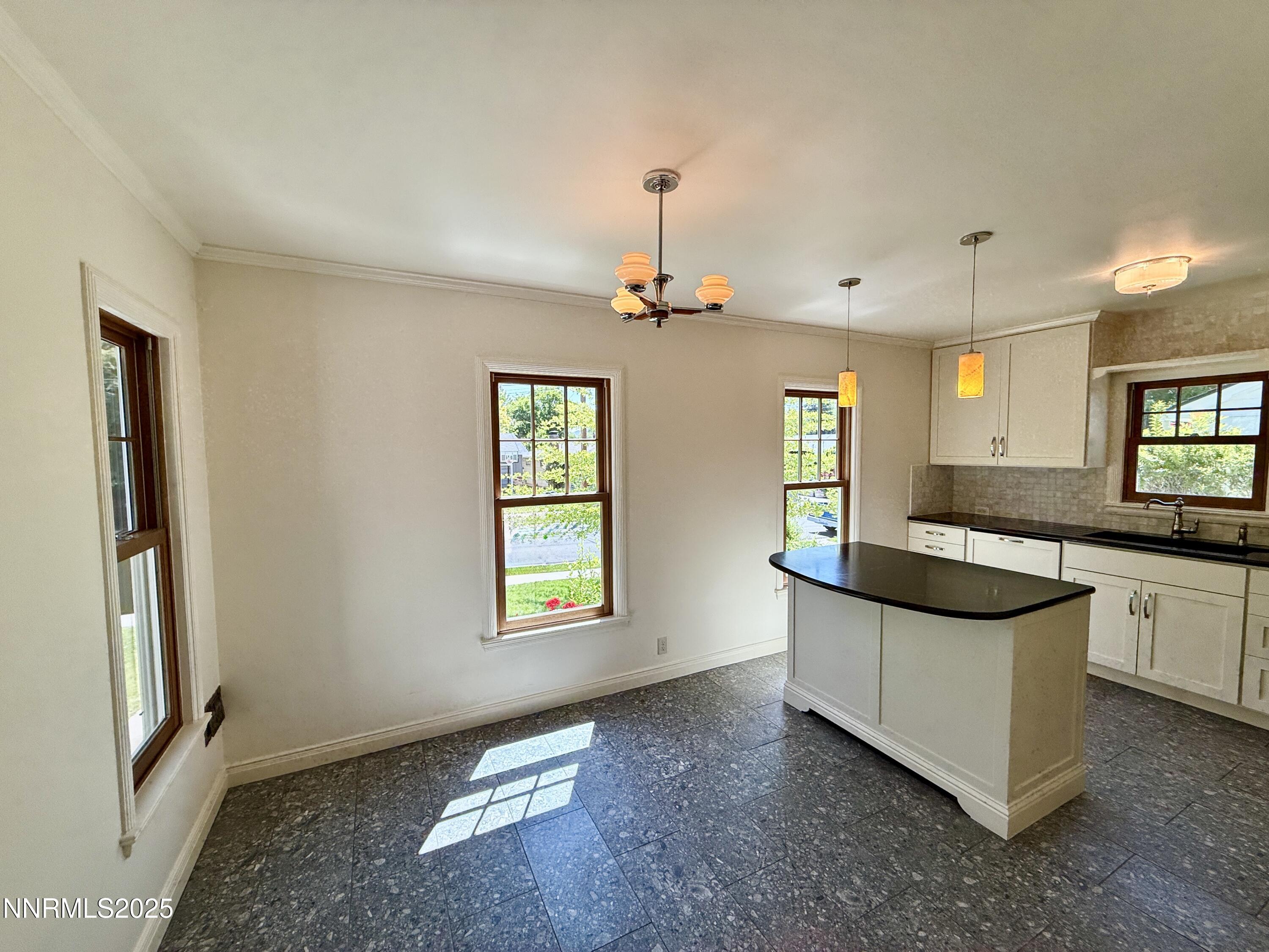 1423 Gordon Avenue Reno, NV 89509 - Photo 7 of 28 a kitchen with granite countertop a sink and cabinets