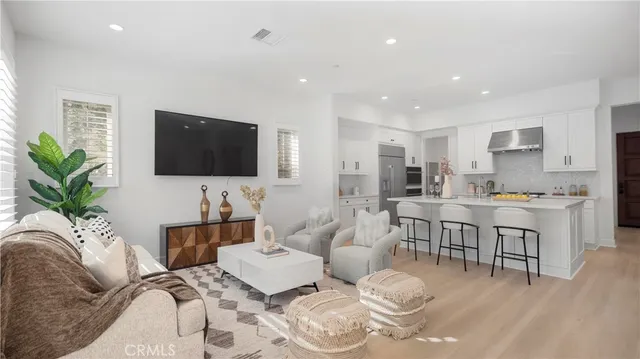 a living room with furniture and view of kitchen
