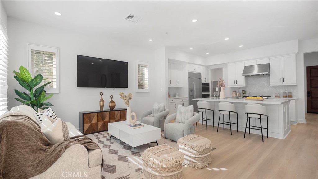 138 Jayhawk Irvine, CA 92602 - Photo 15 of 50 a living room with furniture kitchen view and a flat screen tv