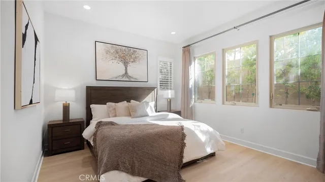 a bedroom with a bed and a painting on the wall